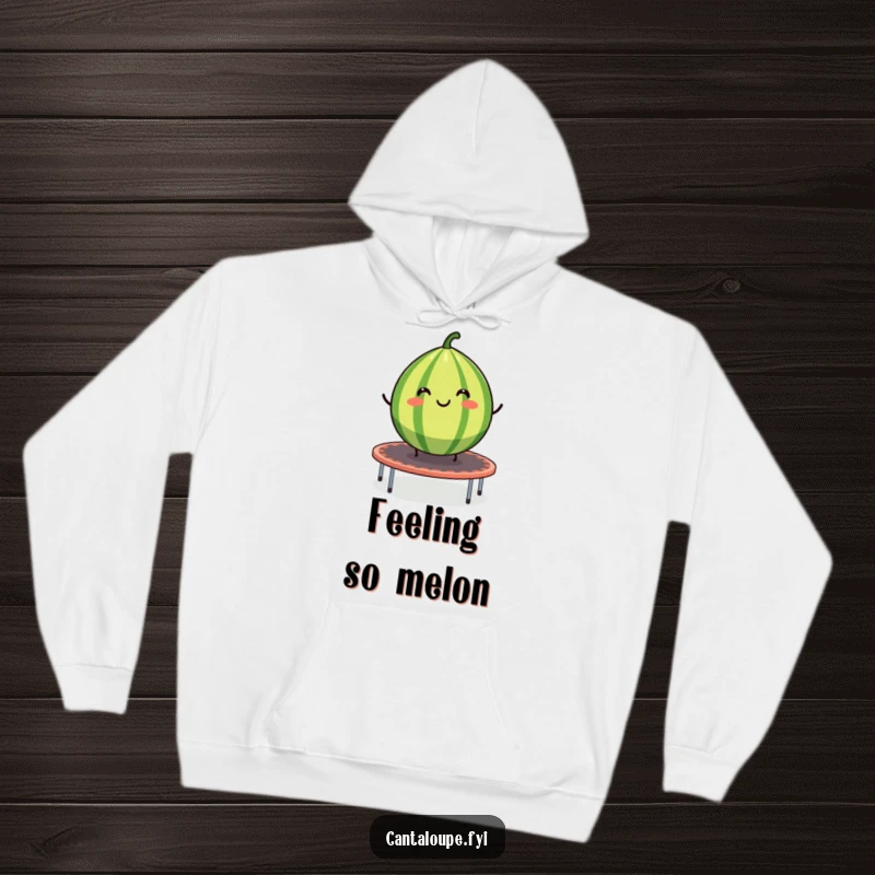 Funny hoodie featuring a smiling cantaloupe segment bouncing on a trampoline, a humorous and warm piece of clothing.